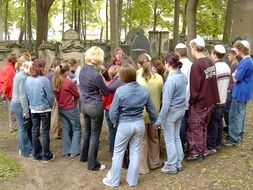 group of young people and teacher on jewish cemetery, germany, dresden, neustadt