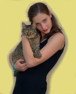 photo of a girl with a cat in her arms