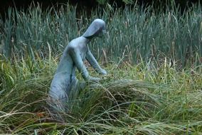 bronze statue of the girl in a meadow