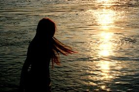 girl with disheveled long hair at sea