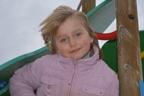 happy child girl in pink jacket