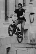 a stunt mading a spectacular jump on a bike