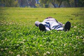 Male is sleeping on the grass