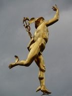 mercury column, golden statue at grey sky, germany, stuttgart