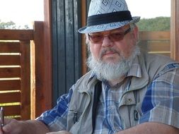 bearded man sitting on the terrace
