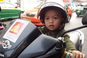 little boy on a motorcycle in bangkok