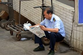 reading the newspaper during the break