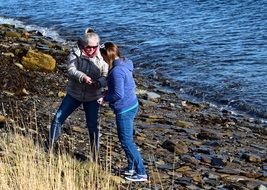 beachcombing mother with daughter