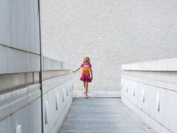 girl walks upstairs federal hall of arts