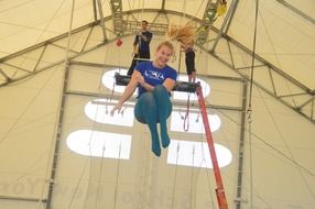 Acrobat girl trains in the circus.