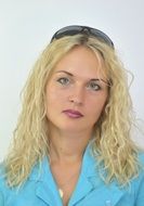 blonde girl with wavy hair and glasses on her head