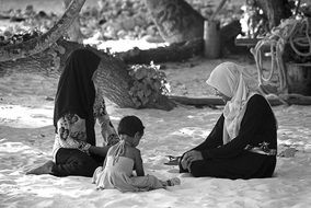 local people in the Maldives are resting on the sand