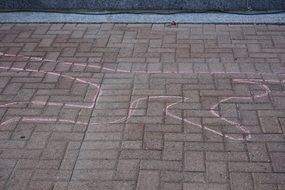 the outline of a person on the pavement