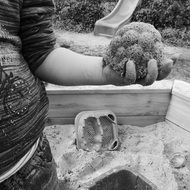 child hand with sand cake