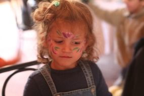 caucasian child girl with painted face