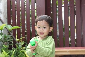 boy with a water gun in the yard