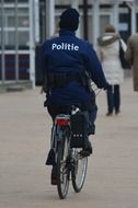 policeman is riding on a bike