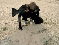 child in superhero costume on the beach