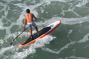 man on surfboard on water