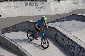 young man riding bike train drive