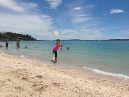 Playing with frisbee on the beach