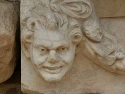 antique relief with mimic face closeup