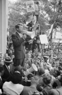 A black and white photograph of Robert Kennedy on stage