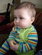 Portrait of little baby in striped clothes