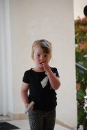a girl with a hand in her mouth