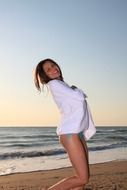 girl in a white towel on the beach