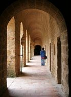 man walking down the hall of a building in france