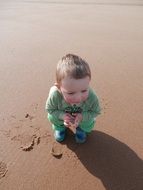 boy sitting on the beach