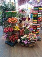 dark skin man statue among tulips in flower shop