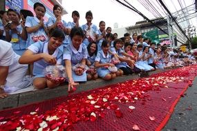 Buddhist ceremony with colorful flowers in Thailand