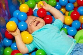 happy baby among bright balls