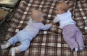 children on a plaid blanket