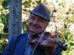 Old gypsy with a violin on the nature