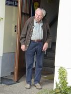 grandpa is standing at the entrance to the house