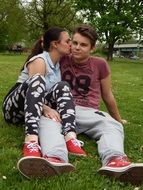 couple in love sitting on the green grass