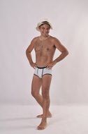 nude man in hat and boxer pants