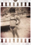 child on beach old photo