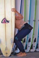 man holds a surfboard