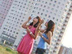 two beautiful girls with soap bubbles