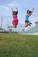 jumping girls on the meadow