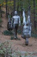 men statues in the forest