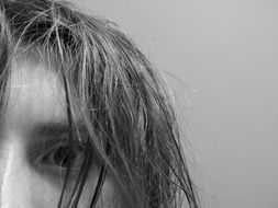 black and white image of a girl with tousled hair