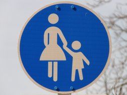 blue sign about a woman with a child