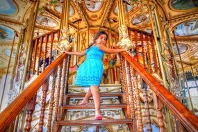 little girl on a golden carousel