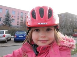 girl in a pink bicycle helmet