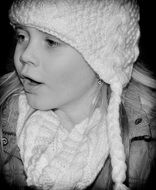 child face in winter, black and white background